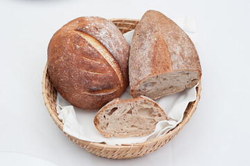 Two Loaves of Homemade Bread in a Basket, isolated