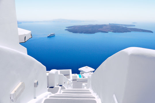 white wash staircases on santorini island, greece. the view toward caldera sea with cruise ship awai