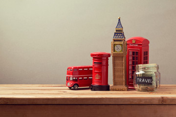 Wall Mural - Travel to Great Britain concept with souvenirs and money box jar. Planning summer vacation, money budget trip concept.