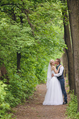  Young wedding couple enjoying romantic moments outside on a summer meadow