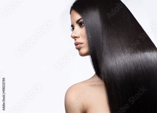 Beautiful brunette girl in move with a perfectly smooth hair, and classic make-up Canvas Print