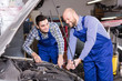 © JackF - Two car mechanics at workshop