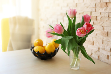 Fototapete - Bouquet of pink tulips on a white table.