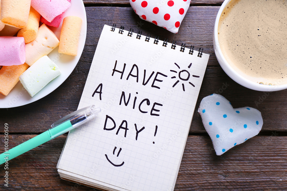 Cup of coffee, marshmallows and note HAVE A NICE DAY on wooden background