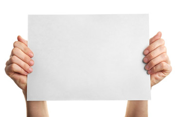 Male hands holding clean sheet of paper, isolated on white