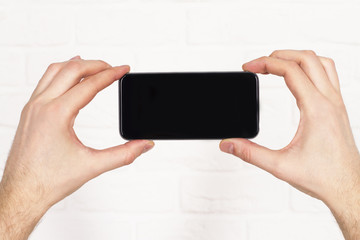 Aufkleber - Male hands holding phone