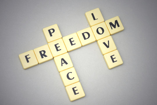 words freedom, peace and love on a gray background