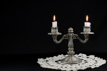 Old Silver Candlestick With Two Arms On A Black Background