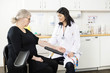 © Tyler Olson - Doctor Touching Senior Patient's Arm Before Blood Test In Clinic