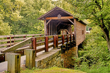 Historic Old Covered Bridge Surrounded With Greenery.