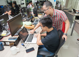 Asian Colleagues Software Developers Team Sitting At Desk