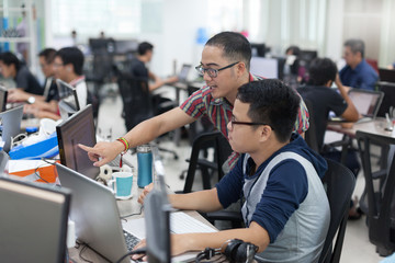 asian colleagues software developers team sitting at desk working