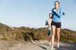© Sergey Nivens - Sport runner jogging on beach working out with her partner