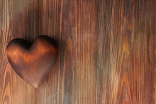 Brown Heart On Wooden Background