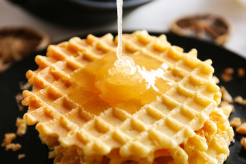 Wall Mural - Fresh tasty waffles with honey, closeup