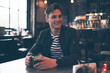 © ysbrandcosijn - Smiling man sitting at table in bar enjoying fresh mint tea