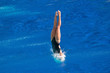 Breaking the surface. Female diving champion entering the water with minimum splash