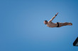 © Microgen - High diving. Diver leaps from high platform