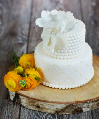 Wall Mural - Cake covered with white fondant and buttercups.