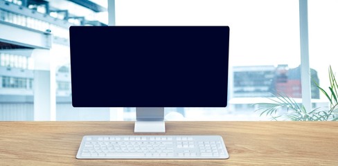 Poster - Composite image of a computer over a desk 