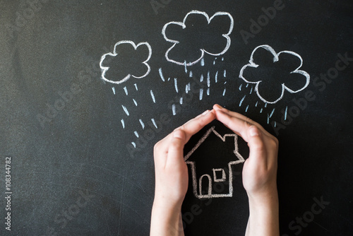 Fotografie, Obraz hands protects a house from the elements - rain or storm