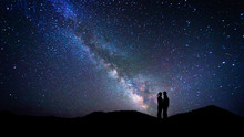 Couple Of Lovers Kissing Under The Milky Way