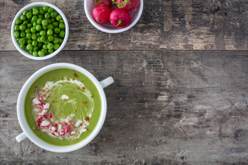 Poster - Pea cream with radishes on a rustic wooden background
