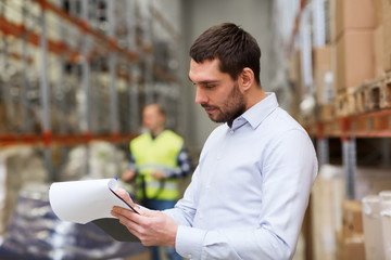 Sticker - businessman writing to clipboard at warehouse