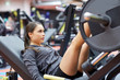 © Syda Productions - woman flexing muscles on leg press machine in gym