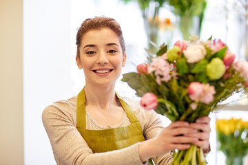 Canvas Print - smiling florist woman making bunch at flower shop