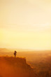 © Alexandr Vasilyev - Boy with tourist on a cliff at sunset