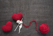Crocheted Red Hearts On A Grunge Board