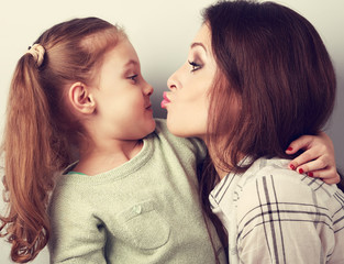 funny amusing young mother wanting to kiss her comical grimacing