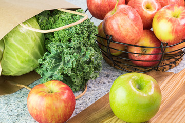 Wall Mural - Farm organic apples, kale and green cabbage on a kitchen table.