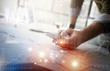 © SFIO CRACHO - Business concept picture.Finance manager working new startup project modern office.Touching contemporary smartphone. Worldwide connection technology,stock exchanges graphics interface. Horizontal