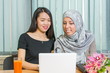 © creativefamily - Asian and muslim girls working on a laptop
