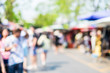 Blurred background : people shopping at market fair in sunny day