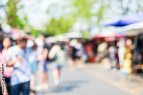 Fotografia Blurred background : people shopping at market fair in sunny day