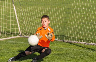 boy goalkeeper defends