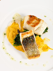 Wall Mural - Fine dining Seabass fillets on carrot potato purree and spices