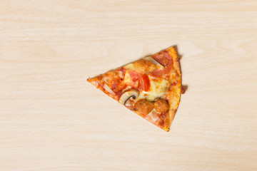 Cut off slice pizza on wood