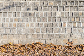 Wall Mural - Traditional Ancient stone wall and Dry leaf, pattern and backgro