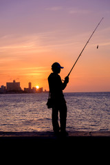 Wall Mural - Sunset in Havana with the silhouette of a fisherman