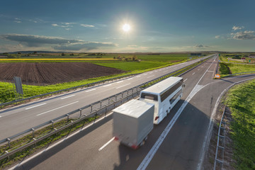 Wall Mural - Fast travel bus in motion blur on the highway at sunny day