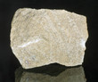 Mineral stone - sandstone. Most sandstone is composed of quartz and/or feldspar because these are the most common minerals in the Earth's crust. 
