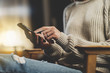 © iana_kolesnikova - Close-up of female hands using smartphone at home vintage interior, hipster girl typing message while sitting at modern coffeeshop at night