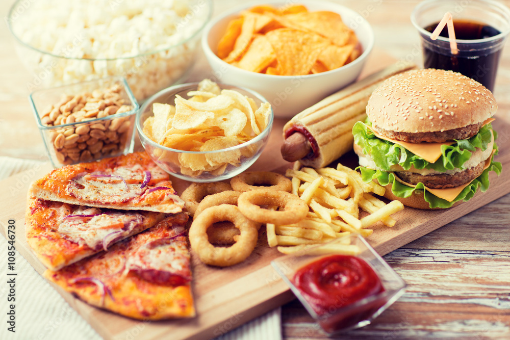 close up of fast food snacks and drink on table - obrazy, fototapety, plakaty 