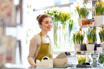 Canvas Print - smiling florist woman at flower shop cashbox