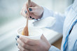 © Room 76 Photography - A cup of fresh yogurt in woman's hands