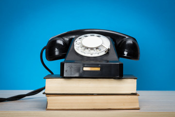 Poster - Retro telephone on wood table for old style background